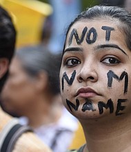 People take part in a Not In My Name protest at Parliament Street in New Dehli on April 15.