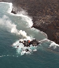 Lava from the Hawaii volcano has created a tiny new island off its coast
