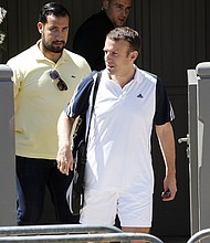 Emmanuel Macron leaves his house in tennis gear with Alexandre Benalla, left, in June 2017.