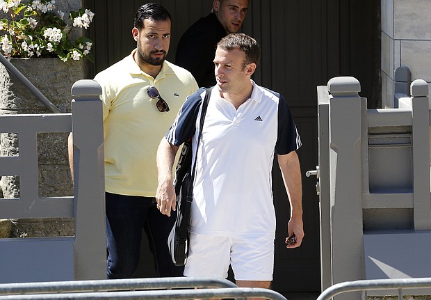 Emmanuel Macron leaves his house in tennis gear with Alexandre Benalla, left, in June 2017.