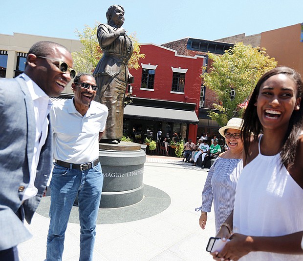 Courtyard of the Maggie L. Walker National Historic Site at 2nd and Leigh streets in Jackson Ward. Liza Mickens shares a laugh Saturday at the statue of her great-great-grandmother, Maggie L. Walker, in Downtown with, from left, Mayor Levar M. Stoney, and her parents, Dr. Johnny Mickens III and Faithe Norrell at the the 154th birthday celebration for Mrs. Walker and the ceremony recognizing graduates of the park service’s Maggie L. Walker Summer Youth Leadership Institute. 