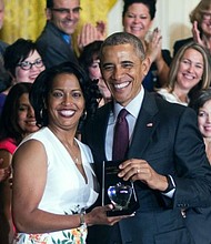 Jahana Hayes, left, a high school history teacher from Waterbury, CT, celebrates winning the 2016 National Teacher of the Year with President Barack Obama at the White House in Washington, May 3, 2016. (Jim Watson/AFP/Getty Images)