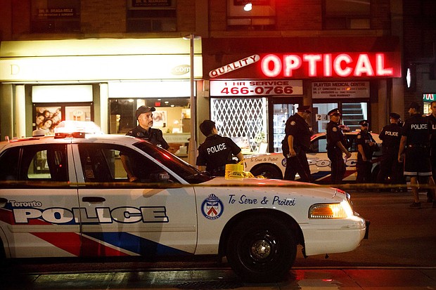 A woman was killed and 13 others injured in a shooting in Toronto on Sunday night, Police Chief Mark Saunders said.
