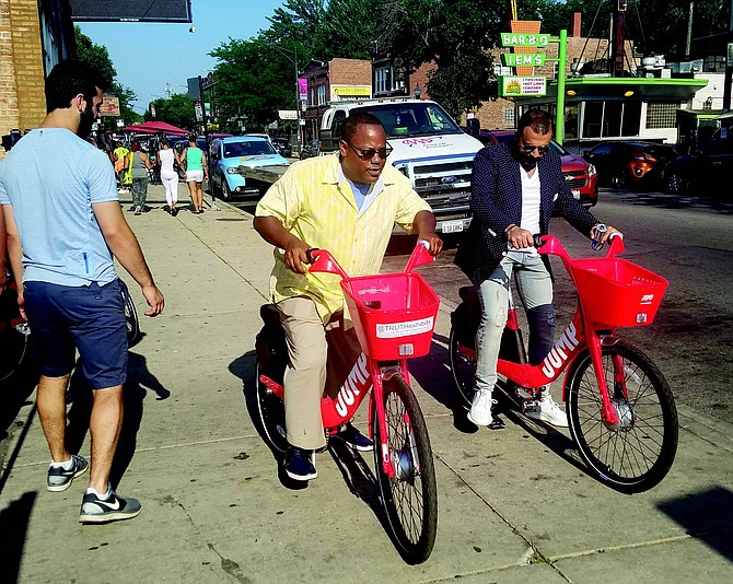 Alderman Roderick Sawyer and Ahmad Elkhatib, owner of A&S Beverages, recently rode Uber Jump bikes at Dining on the 5, a community engagement effort currently happening on 75th Street in Chatham.