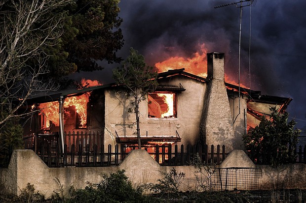 A house burns during a wildfire in Kineta, near Athens, on July 23.