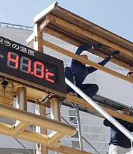 An outdoor thermometer reads 41.0 degrees Celsius (105.8 degrees Fahrenheit) in Kumagaya city, north of Tokyo, Monday, July 23, 2018.