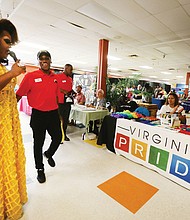 Virginia is for lovers and pride
Alvion Davenport, left, Ms. Black RVA Pride takes the microphone to highlight several of the organizations and vendors at last Saturday’s inaugural Black Pride RVA at Diversity Richmond in North Side. The two-day event, designed to educate, embrace and celebrate the unique experiences of Richmond’s black LGBTQ community, drew several hundred people despite rain that moved the event indoors. Featured were speakers and workshops on a variety of topics, entertainment and a worship service Sunday at Third Street Bethel AME Church. Intern Tariq Crumbly, a recent Virginia Commonwealth University graduate, helped with the event.
