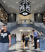 Principal Brandi Davis waves in the lobby of the I Promise School. “We are going to be that groundbreaking school that will be a nationally recognized model for urban and public school excellence,” she said. (Wally Skalij / Los Angeles Times)