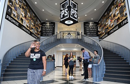 Principal Brandi Davis waves in the lobby of the I Promise School. “We are going to be that groundbreaking school that will be a nationally recognized model for urban and public school excellence,” she said. (Wally Skalij / Los Angeles Times)