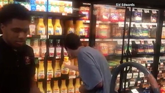 A grocery store employee is being lauded for helping a teen with autism stock shelves in a fridge.