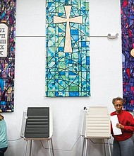 In this November 2016 photo, voters fill our their ballots at a polling place inside Pleasant Ridge Presbyterian Church in Cincinnati.
