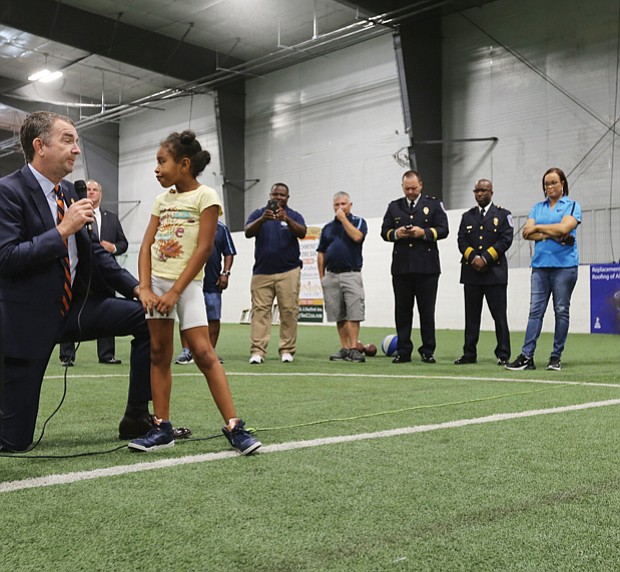 Gov. Ralph S. Northam takes a knee to hear the question posed by 9-year-old Kimoni Jenkins, 9, Wednesday morning during his visit to the Richmond Police Athletic League Summer Camp in North Side. The governor spent an hour fielding questions from the 130 youngsters at the camp.