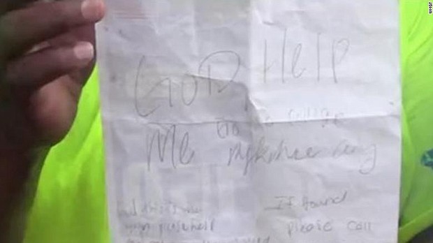 Baptist minister Jerome Jones holds the note Mykehia Curry tied to some balloons. Jones found the note in another town and decided to get her what she needed for college.