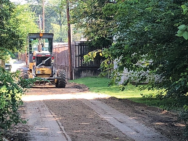 William Smyre, a member of a DPW crew, grades an alley Monday in the 2900 block of Barton Avenue in North Side. He was part of a city Department of Public Works crew operating in the East End on Monday. 