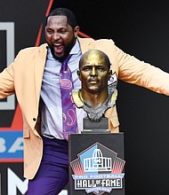 Former Baltimore Ravens linebacker Ray Lewis dances with joy beside his bust during his speech at the Pro Football Hall of Fame induction ceremony last Saturday in Canton, Ohio.