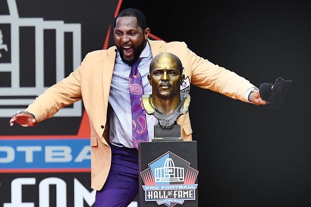Former Baltimore Ravens linebacker Ray Lewis dances with joy beside his bust during his speech at the Pro Football Hall of Fame induction ceremony last Saturday in Canton, Ohio.
