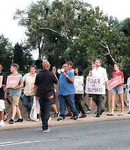 Members of the Southside Chapter of the New Virginia Majority call for Richmond Police transparency and accountability during a community march Monday night across the Mayo Bridge.