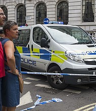 Jean and Carole Gautier, from Amiens, France, stand outside a police cordon. The couple was on their way to visit Westminster Abbey during their first visit to London, when the crash happened.
