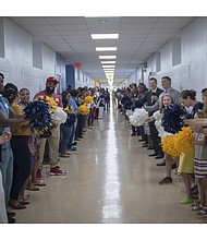Teachers, parents, and community members cheer students on the first day of school for the 2018-2019 year