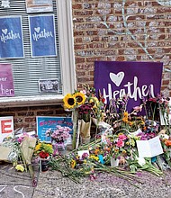 Flowers adorn the curbside memorial Saturday in Charlottesville’s downtown where 32-year-old Heather Heyer was killed and dozens of others were injured on Aug. 12, 2017, by a white nationalist who drove his car into a crowd of counterprotesters.