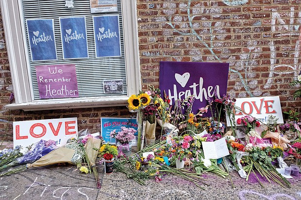 Flowers adorn the curbside memorial Saturday in Charlottesville’s downtown where 32-year-old Heather Heyer was killed and dozens of others were injured on Aug. 12, 2017, by a white nationalist who drove his car into a crowd of counterprotesters.