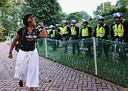 A University of Virginia student expresses her disgust at State Police who blocked off part of the campus Saturday where white supremacists carrying torches attacked members and supporters of Black Lives Matter last August.