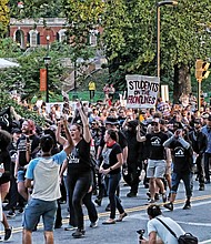 Hundreds of students and activists march down Rugby Road in Charlottesville on Saturday, marking the year anniversary of the bloody violence that broke out during last year’s rally by white supremacists, Ku Klux Klan and neo-Nazis.