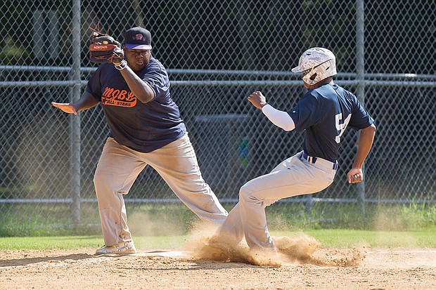 Mitch Jackson, right, narrowly misses being tagged out by Deyshaun Miles as he comes into third base during the Metropolitan Junior Baseball League All-Star Game last Saturday. 