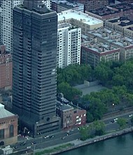 Residents of a luxury high-rise building on the Upper East Side are living in fear after a mystery shooter fired bullets into apartment windows twice in the last week.