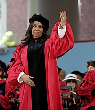 Ms. Franklin acknowledges the cheering crowd as she stands to receive an honorary degree at Harvard University during the May 2014 commencement ceremony.
