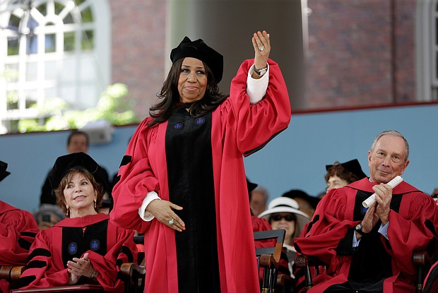 Ms. Franklin acknowledges the cheering crowd as she stands to receive an honorary degree at Harvard University during the May 2014 commencement ceremony.