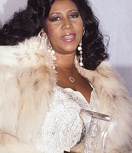 Ms. Franklin shows off the Grammy Legend Award she received during a ceremony Dec. 5, 1990, at the Theater Royale in New York.