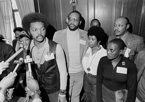 Ms. Franklin, second from right, stands with the Rev. Jesse Jackson Sr. as he speaks with reporters at the Operation PUSH Soul Picnic in March 1972 at the 142nd Street Armory in New York City. With them are, from left, Betty Shabazz, widow of Malcolm X; PUSH Vice President Tom Todd; South African singer Miriam Makeba; and Congressman Louis Stokes of Ohio.
