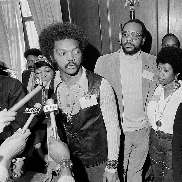 Ms. Franklin, second from right, stands with the Rev. Jesse Jackson Sr. as he speaks with reporters at the Operation PUSH Soul Picnic in March 1972 at the 142nd Street Armory in New York City. With them are, from left, Betty Shabazz, widow of Malcolm X; PUSH Vice President Tom Todd; South African singer Miriam Makeba; and Congressman Louis Stokes of Ohio.
