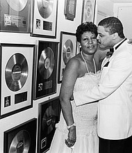 Aretha Franklin receives a kiss from beau Willie Wilkerson at Franklin's Birthday Celebration held at her sprawling suburban Detroit estate in 1987. 