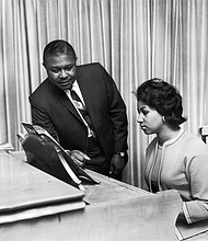 Aretha Franklin receives music advice from her father, the Rev. C.L. Franklin, in this undated photo.