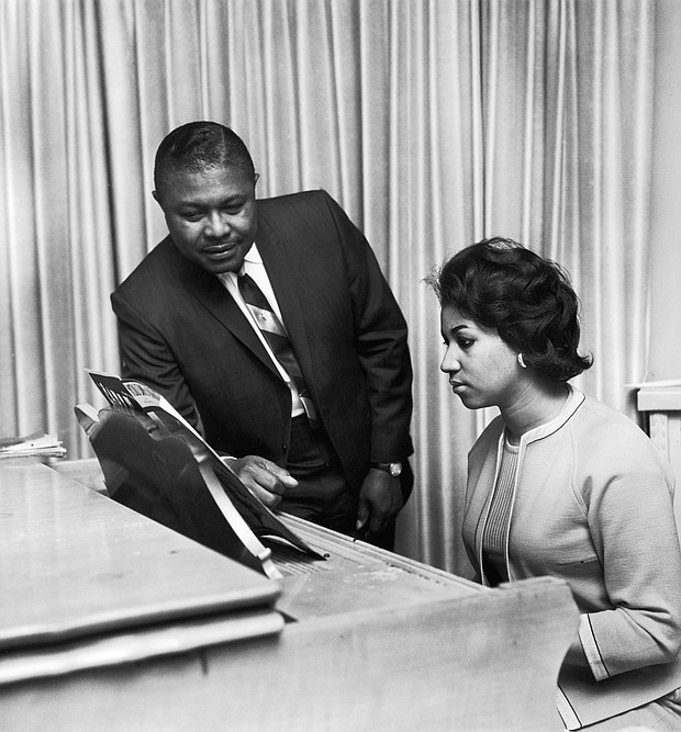 Aretha Franklin receives music advice from her father, the Rev. C.L. Franklin, in this undated photo.