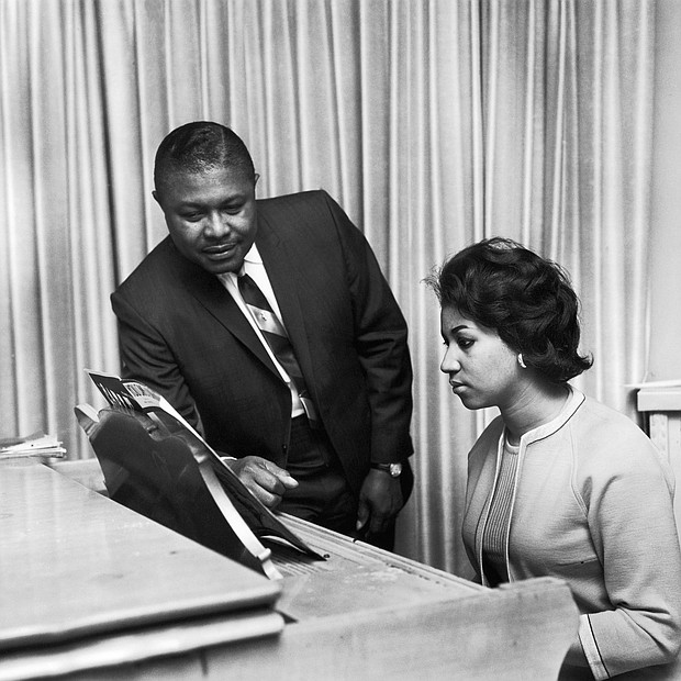 Aretha Franklin receives music advice from her father, the Rev. C.L. Franklin, in this undated photo.