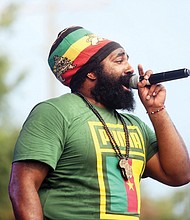 Adwela of Adwela & The Uprising, above left, gets the crowd going during last Saturday’s 28th Annual Down Home Family Reunion. A little rain didn’t dampen the spirits of the crowd that enjoyed music, food, arts and activities that focused on the historic ties between Richmonders and nations in Africa. Above, the crowd reacts to the sounds of Lady E & the Blues Synsations. The free event was sponsored by the Elegba Folklore Society.