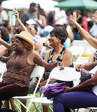 Adwela of Adwela & The Uprising, above left, gets the crowd going during last Saturday’s 28th Annual Down Home Family Reunion. A little rain didn’t dampen the spirits of the crowd that enjoyed music, food, arts and activities that focused on the historic ties between Richmonders and nations in Africa. Above, the crowd reacts to the sounds of Lady E & the Blues Synsations. The free event was sponsored by the Elegba Folklore Society.