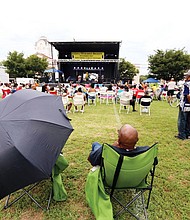Adwela of Adwela & The Uprising, above left, gets the crowd going during last Saturday’s 28th Annual Down Home Family Reunion. A little rain didn’t dampen the spirits of the crowd that enjoyed music, food, arts and activities that focused on the historic ties between Richmonders and nations in Africa. Above, the crowd reacts to the sounds of Lady E & the Blues Synsations. The free event was sponsored by the Elegba Folklore Society.