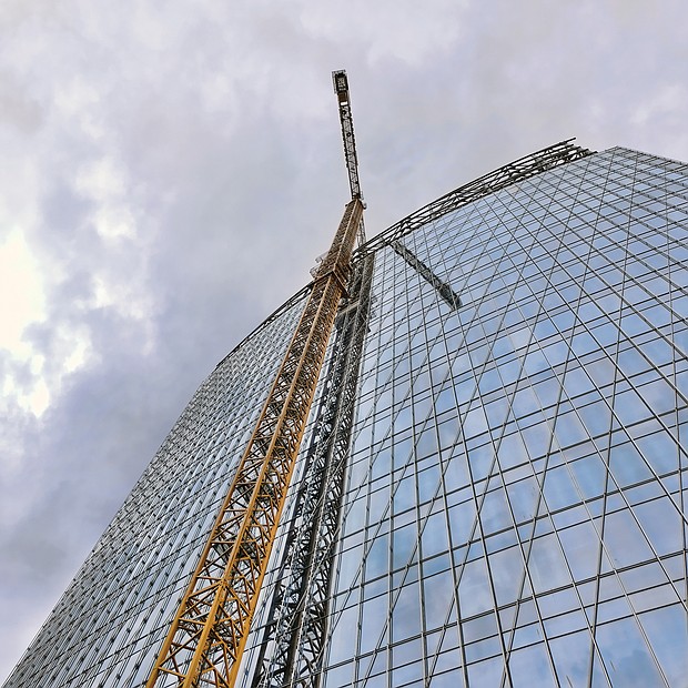 A towering crane’s reflection almost looks like a staircase rising up the side of this 20-story Downtown building under construction for Dominion Energy in the block bounded by 6th, 7th, Canal and Cary streets. Crews and cranes have been at the site since work began last year. The building will be known as 600 Canal Place when it opens next year. Dominion Energy has presented plans to a construct a second building to replace its 21-story Virginia headquarters, One James River Plaza, located next door at 701 E. Cary St. 