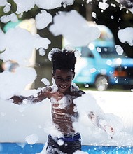 Last glorious days of summer
Deondre McKnight Williams, 9, frolics in the cool waters and bubbles of a “Foam Pit” set up last Friday at the Byrd Park Round House for Playground Day, hosted by the Richmond Department for Parks, Recreation and Community Facilities. Youngsters everywhere are fitting in the last days of fun before the new school year starts Sept. 4.(Regina H. Boone/Richmond Free Press)