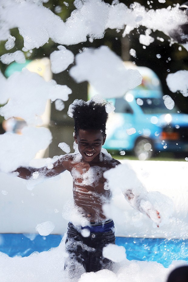 Last glorious days of summer
Deondre McKnight Williams, 9, frolics in the cool waters and bubbles of a “Foam Pit” set up last Friday at the Byrd Park Round House for Playground Day, hosted by the Richmond Department for Parks, Recreation and Community Facilities. Youngsters everywhere are fitting in the last days of fun before the new school year starts Sept. 4.(Regina H. Boone/Richmond Free Press)