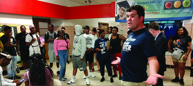 School Board member James “Scott” Barlow, right, welcomes more than 60 volunteers Tuesday at Carver Elementary School to help clean and spruce up the school through RPS Shines!