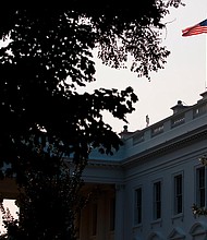An American flag above the White House flies at full-staff less than 48 hours after the death of Sen. John McCain, Monday, Aug. 27, 2018, in Washington. (AP Photo/Evan Vucci)