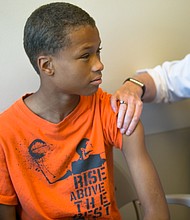 Health checks
Sixth-grader Nehemiah Eubanks gets one of the required vaccines during last Friday’s free back-to-school physicals and health checks by the state’s Richmond Health District Office. The annual event, conducted in partnership with the Virginia Commonwealth University School of Nursing, provided the necessary checks for youngsters for Head Start and school entry.