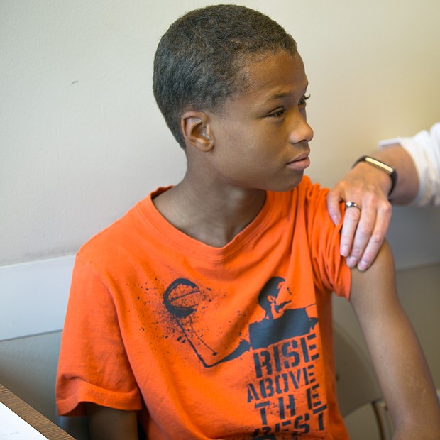 Health checks
Sixth-grader Nehemiah Eubanks gets one of the required vaccines during last Friday’s free back-to-school physicals and health checks by the state’s Richmond Health District Office. The annual event, conducted in partnership with the Virginia Commonwealth University School of Nursing, provided the necessary checks for youngsters for Head Start and school entry.
