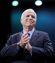 U.S. Sen. John McCain listens as he’s introduced at an October 2008 campaign rally in Fayetteville, N.C., during his run for president against then-Sen. Barack Obama.