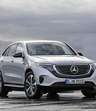 The Mercedes-Benz EQC is differentiated by a black band running under the grill and a bar of white light above it.